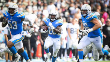 CARSON, CA - OCTOBER 07: Running back Melvin Gordon #28 of the Los Angeles Chargers runs after a catch with center Mike Pouncey #53 and offensive guard Dan Feeney #66 during the second quarter against the Oakland Raiders at StubHub Center on October 7, 2018 in Carson, California. (Photo by Harry How/Getty Images)