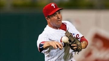 Jul 11, 2013; Philadelphia, PA, USA; Philadelphia Phillies third baseman John McDonald (4) throws to first base during the eighth inning against the Washington Nationals at Citizens Bank Park. The Phillies defeated the Nationals 3-1. Mandatory Credit: Howard Smith-USA TODAY Sports