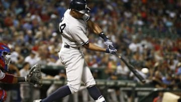 Jul 28, 2015; Arlington, TX, USA; New York Yankees right fielder Chris Young (24) connects for an RBI double against the Texas Rangers during the sixth inning of a baseball game at Globe Life Park in Arlington. Mandatory Credit: Jim Cowsert-USA TODAY Sports