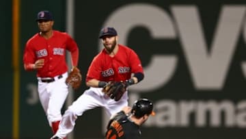 Sep 25, 2015; Boston, MA, USA; Boston Red Sox second baseman Dustin Pedroia (15) turns a double play as Baltimore Orioles left fielder Nolan Reimold (14) slides in during the first inning at Fenway Park. Mandatory Credit: Mark L. Baer-USA TODAY Sports