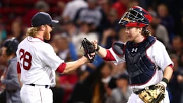 Sep 21, 2015; Boston, MA, USA; Boston Red Sox relief pitcher Robbie Ross Jr. (28) and catcher Ryan Hanigan (R) celebrate after defeating the Tampa Bay Rays at Fenway Park. Mandatory Credit: Mark L. Baer-USA TODAY Sports