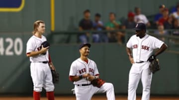 Sep 8, 2015; Boston, MA, USA; (From left to right) Boston Red Sox second baseman Brock Holt (26), center fielder Mookie Betts (50) and right fielder Jackie Bradley Jr. (25) speak during a pitching change during the seventh inning of a game against the Toronto Blue Jays at Fenway Park. Mandatory Credit: Mark L. Baer-USA TODAY Sports
