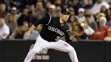 Sep 18, 2015; Denver, CO, USA; Colorado Rockies first baseman Justin Morneau (33) pulls in a catch for an out in the eighth inning against the San Diego Padres at Coors Field. Mandatory Credit: Ron Chenoy-USA TODAY Sports
