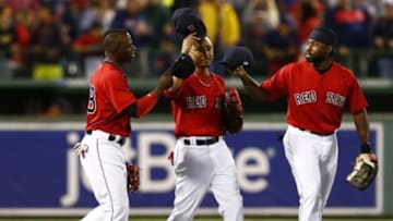 Sep 4, 2015; Boston, MA, USA; Boston Red Sox right fielder Rusney Castillo (L), center fielder Mookie Betts (C), and right fielder Jackie Bradley Jr. (25) celebrate after defeating the Philadelphia Phillies at Fenway Park. Mandatory Credit: Mark L. Baer-USA TODAY Sports