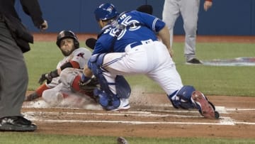 Apr 10, 2016; Toronto, Ontario, CAN; Toronto Blue Jays catcher Russell Martin (55) tags out Boston Red Sox second baseman Dustin Pedroia (15) at home plate during the 3rd inning in a game at Rogers Centre. Mandatory Credit: Nick Turchiaro-USA TODAY Sports