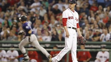 May 26, 2016; Boston, MA, USA; Boston Red Sox starting pitcher Clay Buchholz (11) watches as Colorado Rockies catcher Dustin Garneau (13) rounds the bases after hitting a two run homer in the fifth inning at Fenway Park. Mandatory Credit: David Butler II-USA TODAY Sports