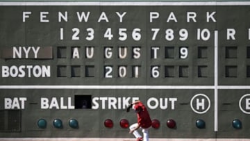 Aug 9, 2016; Boston, MA, USA; Boston Red Sox left fielder Andrew Benintendi (40) loses his balance fielding a ball off the green monster prior to a game against the New York Yankees at Fenway Park. Mandatory Credit: Bob DeChiara-USA TODAY Sports