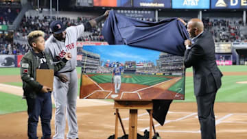 Sep 29, 2016; Bronx, NY, USA; Boston Red Sox designated hitter David Ortiz (34) assisted by former Yankees pitcher Mariano Rivera unveil a painting given as a gift to David Ortiz by the New York Yankees at Yankee Stadium. Mandatory Credit: Anthony Gruppuso-USA TODAY Sports