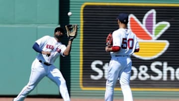 Jul 3, 2016; Boston, MA, USA; Boston Red Sox center fielder Jackie Bradley Jr. (25) makes a catch in front of right fielder Mookie Betts (50) during the fifth inning against the Los Angeles Angels at Fenway Park. Mandatory Credit: Bob DeChiara-USA TODAY Sports