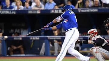 Oct 18, 2016; Toronto, Ontario, CAN; Toronto Blue Jays first baseman Edwin Encarnacion (10) hits an RBI single during the seventh inning against the Cleveland Indians in game four of the 2016 ALCS playoff baseball series at Rogers Centre. Mandatory Credit: Nick Turchiaro-USA TODAY Sports