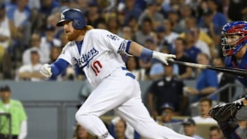 Oct 20, 2016; Los Angeles, CA, USA; Los Angeles Dodgers third baseman Justin Turner (10) connects for a single in the third inning against the Chicago Cubs in game five of the 2016 NLCS playoff baseball series against the Los Angeles Dodgers at Dodger Stadium. Mandatory Credit: Richard Mackson-USA TODAY Sports