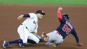 HOUSTON, TEXAS - OCTOBER 22: Carlos Correa #1 of the Houston Astros tags out Alex Verdugo #99 of the Boston Red Sox as he attempted to steal second base during the seventh inning in Game Six of the American League Championship Series at Minute Maid Park on October 22, 2021 in Houston, Texas. (Photo by Bob Levey/Getty Images)