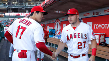 ANAHEIM, CALIFORNIA - APRIL 09: Shohei Ohtani #17 shakes hands with Mike Trout #27 of the Los Angeles Angels in the dugout prior to a game against the Houston Astros at Angel Stadium of Anaheim on April 09, 2022 in Anaheim, California. (Photo by Michael Owens/Getty Images)