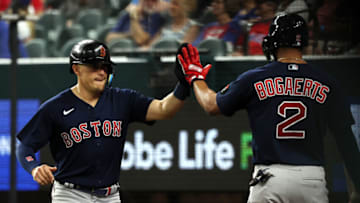 ARLINGTON, TEXAS - MAY 13: Enrique Hernandez #5 gets a high five from Xander Bogaerts #2 of the Boston Red Sox after scoring in the third inning against the Texas Rangers at Globe Life Field on May 13, 2022 in Arlington, Texas. (Photo by Richard Rodriguez/Getty Images)