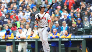SEATTLE, WASHINGTON - JUNE 12: Rafael Devers #11 of the Boston Red Sox flips his bat after hitting a two-run home run against the Seattle Mariners to take a 2-0 lead during the eighth inning at T-Mobile Park on June 12, 2022 in Seattle, Washington. (Photo by Abbie Parr/Getty Images)