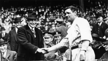 Great all-round baseball player, Babe Ruth (George Herman Ruth, 1895 - 1948) shakes hands with the 29th President of the USA, Warren Harding. After the handshake Babe Ruth hit a home run to help his team, the New York Yankees win the third game of the series with the Wash. (Photo by Keystone/Getty Images)