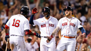 BOSTON, MA - JULY 10: Xander Bogaerts #2 and Alex Verdugo #99 of the Boston Red Sox high five Franchy Cordero #16 after scoring during the seventh inning of a game against the New York Yankees on July 10, 2022 at Fenway Park in Boston, Massachusetts. (Photo by Billie Weiss/Boston Red Sox/Getty Images)