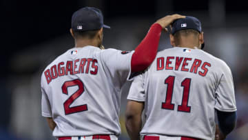 SOUTH WILLIAMSPORT, PENNSYLVANIA - AUGUST 21: Xander Bogaerts #2 of the Boston Red Sox reacts with Rafael Devers #11 of the Boston Red Sox during the third inning of the 2022 Little League Classic game against the Baltimore Orioles on August 21, 2022 at Bowman Field on August 21, 2022 in South Williamsport, Pennsylvania/ (Photo by Maddie Malhotra/Boston Red Sox/Getty Images)