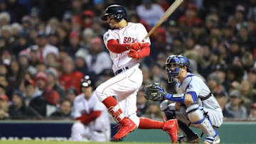 BOSTON, MA - OCTOBER 24: Mookie Betts #50 of the Boston Red Sox hits a single during the fifth inning against the Los Angeles Dodgers in Game Two of the 2018 World Series at Fenway Park on October 24, 2018 in Boston, Massachusetts. (Photo by Elsa/Getty Images)
