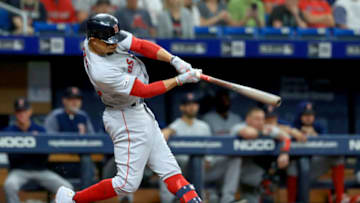 ST PETERSBURG, FLORIDA - JULY 24: Mookie Betts #50 of the Boston Red Sox hits a double in the third inning during a game against the Tampa Bay Rays at Tropicana Field on July 24, 2019 in St Petersburg, Florida. (Photo by Mike Ehrmann/Getty Images)