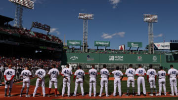 BOSTON, MASSACHUSETTS - APRIL 15: Members of the Boston Red Sox stand on the first base line on Opening Day at Fenway Park on April 15, 2022 in Boston, Massachusetts. All players are wearing the number 42 in honor of Jackie Robinson Day. (Photo by Maddie Meyer/Getty Images)