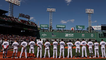 BOSTON, MASSACHUSETTS - APRIL 15: Members of the Boston Red Sox stand on the first base line on Opening Day at Fenway Park on April 15, 2022 in Boston, Massachusetts. All players are wearing the number 42 in honor of Jackie Robinson Day. (Photo by Maddie Meyer/Getty Images)
