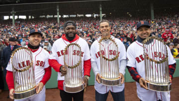 BOSTON, MA - APRIL 9: Steve Pearce #25, former designated hitter David Ortiz, former first baseman Mike Lowell, and former left fielder Manny Ramirez of the Boston Red Sox pose for a photograph with the 2004, 2007, 2013, and 2018 World Series trophies during a 2018 World Series championship ring ceremony before the Opening Day game against the Toronto Blue Jays on April 9, 2019 at Fenway Park in Boston, Massachusetts. All four players won the World Series Most Valuable Player award. (Photo by Billie Weiss/Boston Red Sox/Getty Images)