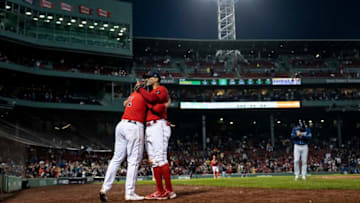 BOSTON, MA - OCTOBER 5: Xander Bogaerts #2 of the Boston Red Sox hugs Rafael Devers #11 as he exits the game during the seventh inning of a game against the Tampa Bay Rays on October 5, 2022 at Fenway Park in Boston, Massachusetts. (Photo by Billie Weiss/Boston Red Sox/Getty Images)
