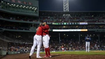 BOSTON, MA - OCTOBER 5: Xander Bogaerts #2 of the Boston Red Sox hugs Rafael Devers #11 as he exits the game during the seventh inning of a game against the Tampa Bay Rays on October 5, 2022 at Fenway Park in Boston, Massachusetts. (Photo by Billie Weiss/Boston Red Sox/Getty Images)
