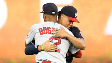 WASHINGTON, DC - OCTOBER 01: Xander Bogaerts #2 of the Boston Red Sox and Juan Soto #22 of the Washington Nationals hug before a baseball game against the Washington Nationals at Nationals Park on October 1, 2021 in Washington, DC. (Photo by Mitchell Layton/Getty Images)