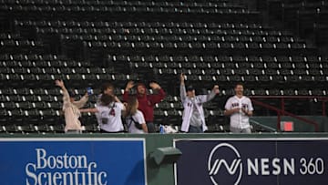 Sep 26, 2022; Boston, Massachusetts, USA; Fans dance in the stands during a rain delay in the game between the Boston Red Sox and Baltimore Orioles at Fenway Park. Mandatory Credit: Bob DeChiara-USA TODAY Sports