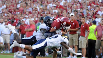 Sep 5, 2015; Norman, OK, USA; Oklahoma Sooners quarterback Baker Mayfield (6) is tackled by Akron Zips linebacker Jatavis Brown (1) and Zips defensive back Larry Hope (2) during the second quarter at Gaylord Family - Oklahoma Memorial Stadium. Mandatory Credit: Mark D. Smith-USA TODAY Sports