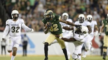 Sep 19, 2015; Denver, CO, USA; Colorado State Rams wide receiver Rashard Higgins (82) stiff arms Colorado Buffaloes defensive back Chidobe Awuzie (4) in the fourth quarter at Sports Authority Field at Mile High. The Buffaloes defeated the Rams 27-24 in overtime. Mandatory Credit: Ron Chenoy-USA TODAY Sports