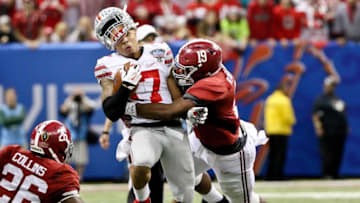 Jan 1, 2015; New Orleans, LA, USA; Alabama Crimson Tide linebacker Reggie Ragland (19) hits Ohio State Buckeyes running back Jalin Marshall (17) knocking his helmet off during the third quarter in the 2015 Sugar Bowl at Mercedes-Benz Superdome. Mandatory Credit: Derick E. Hingle-USA TODAY Sports