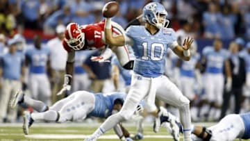 Sep 3, 2016; Atlanta, GA, USA; North Carolina Tar Heels quarterback Mitch Trubisky (10) throws as Georgia Bulldogs linebacker Davin Bellamy (17) is upended behind him during the fourth quarter of the 2016 Chick-Fil-A Kickoff game at Georgia Dome. Georgia won 33-24. Mandatory Credit: Brett Davis-USA TODAY Sports