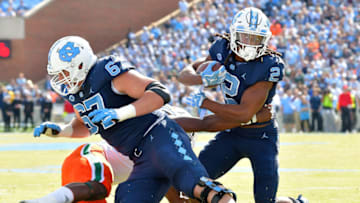 CHAPEL HILL, NC - OCTOBER 28: Charlie Heck #67 blocks for Jordon Brown #2 of the North Carolina Tar Heels during their game against the Miami Hurricanes at Kenan Stadium on October 28, 2017 in Chapel Hill, North Carolina. (Photo by Grant Halverson/Getty Images)