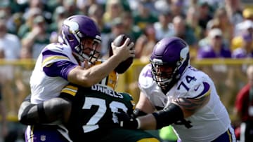 GREEN BAY, WI - SEPTEMBER 16: Mike Daniels #76 of the Green Bay Packers sacks Kirk Cousins #8 of the Minnesota Vikings during the third quarter of a game at Lambeau Field on September 16, 2018 in Green Bay, Wisconsin. (Photo by Jonathan Daniel/Getty Images)