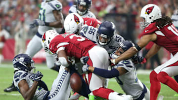 GLENDALE, AZ - SEPTEMBER 30: Running back David Johnson #31 of the Arizona Cardinals fumbles after being hit by linebacker Mychal Kendricks #56, cornerback Tre Flowers #37 and defensive back Bradley McDougald #30 of the Seattle Seahawks during the first quarter at State Farm Stadium on September 30, 2018 in Glendale, Arizona. (Photo by Ralph Freso/Getty Images)