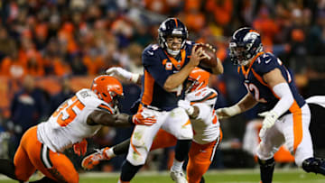 DENVER, CO - DECEMBER 15: Quarterback Case Keenum #4 of the Denver Broncos scrambles to avoid a sack by outside linebacker Genard Avery #55 of the Cleveland Browns in the third quarter of a game at Broncos Stadium at Mile High on December 15, 2018 in Denver, Colorado. (Photo by Matthew Stockman/Getty Images)