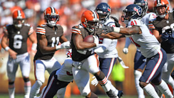 CLEVELAND, OHIO - SEPTEMBER 19: Running back Nick Chubb #24 of the Cleveland Browns tries to avoid a tackle by inside linebacker Zach Cunningham #41 of the Houston Texans during the second half at FirstEnergy Stadium on September 19, 2021 in Cleveland, Ohio. (Photo by Jason Miller/Getty Images)