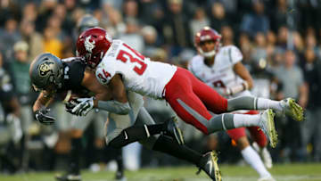 BOULDER, CO - NOVEMBER 19: Wide receiver Jay MacIntyre #14 of the Colorado Buffaloes is tackled by safety Jalen Thompson #34 of the Washington State Cougars after making a catch during the third quarter at Folsom Field on November 19, 2016 in Boulder, Colorado. Colorado defeated Washington State 38-24. (Photo by Justin Edmonds/Getty Images)