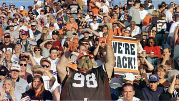 Cleveland Brown fans, led by John "Big Dawg" Thompson (C), cheer their team during pre-game introductions at the AFC-NFC Hall of Fame Game between the Cleveland Browns and the Dallas Cowboys 09 August 1999 at the Pro Football Hall of Fame field at Fawcett Stadium in Canton, Ohio. AFP PHOTO/David MAXWELL (Photo by DAVID MAXWELL / AFP) (Photo credit should read DAVID MAXWELL/AFP via Getty Images)