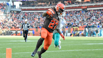CLEVELAND, OHIO - NOVEMBER 24: Running back Kareem Hunt #27 of the Cleveland Browns runs to score a touchdown while under pressure from defensive back Nik Needham #40 of the Miami Dolphins during the first half at FirstEnergy Stadium on November 24, 2019 in Cleveland, Ohio. (Photo by Jason Miller/Getty Images)