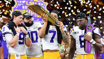NEW ORLEANS, LOUISIANA - JANUARY 13: Grant Delpit #7 of the LSU Tigers kisses the National Championship Trophy after the College Football Playoff National Championship game at the Mercedes Benz Superdome on January 13, 2020 in New Orleans, Louisiana. The LSU Tigers topped the Clemson Tigers, 42-25. (Photo by Alika Jenner/Getty Images)