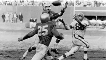Detroit Lions Hall of Fame safety Jack Christiansen intercepts Cleveland Browns Hall of Fame quarterback Otto Grahams pass to Hall of Fame wide receiver Dante Lavelli in a 56-10 loss to the Cleveland Browns in a League Championship game on December 26, 1954 at Cleveland Municipal Stadium in Cleveland, Ohio. (Photo by Tim Culek/Getty Images)