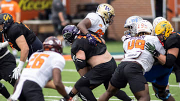Jan 26, 2021; Mobile, Alabama, USA; National offensive lineman Quinn Meinerz of Wisconsin -Whitewater (71) blocks National defensive lineman Levi Onwuzurike of Washington (95) in drills during National team practice during the 2021 Senior Bowl week. Mandatory Credit: Vasha Hunt-USA TODAY Sports