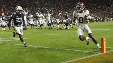 Nov 27, 2021; Auburn, Alabama, USA; Alabama Crimson Tide wide receiver John Metchie III (8) scores the game-winning touchdown against Auburn Tigers defensive back Roger McCreary (23) on a pass at Jordan-Hare Stadium. Alabama defeated Auburn in four overtimes. Mandatory Credit: Gary Cosby Jr.-USA TODAY Sports