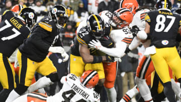 Jan 3, 2022; Pittsburgh, Pennsylvania, USA; Pittsburgh Steelers running back Najee Harris (22) is tackled by Cleveland Browns safety Ronnie Harrison Jr. (33) and linebacker Sione Takitaki (44) during the first quarter at Heinz Field. Mandatory Credit: Philip G. Pavely-USA TODAY Sports
