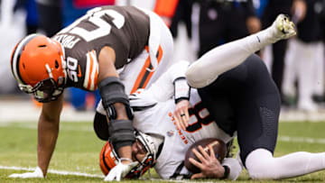 Jan 9, 2022; Cleveland, Ohio, USA; Cleveland Browns linebacker Jacob Phillips (50) sacks Cincinnati Bengals quarterback Brandon Allen (8) during the second quarter at FirstEnergy Stadium. Mandatory Credit: Scott Galvin-USA TODAY Sports