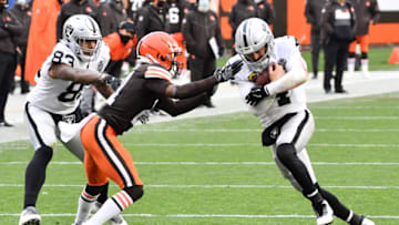Nov 1, 2020; Cleveland, Ohio, USA; Cleveland Browns cornerback Denzel Ward (21) tackles Las Vegas Raiders quarterback Derek Carr (4) during the second half at FirstEnergy Stadium. Mandatory Credit: Ken Blaze-USA TODAY Sports